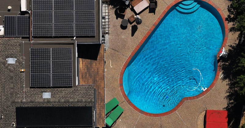 A residential rooftop solar installation with a modern battery storage system in a European neighborhood.