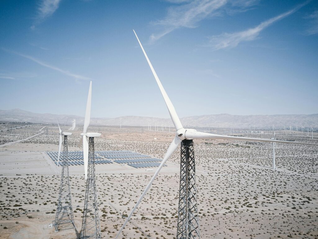 A large-scale solar farm with battery storage containers in the Spanish countryside.