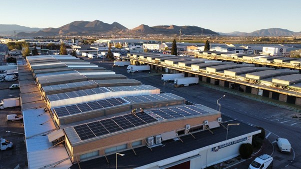 Aerial view of a sprawling industrial park in Andalusia with extensive rooftop solar arrays.