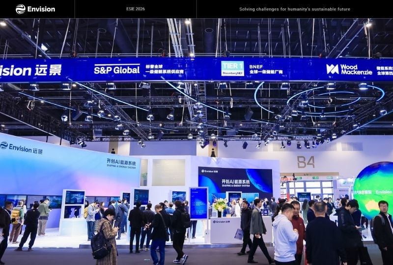 A row of industrial-scale sodium-ion battery storage modules on display at a trade show.