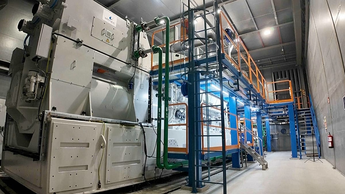 Industrial scale hydrogen engine infrastructure with solar panels in the background