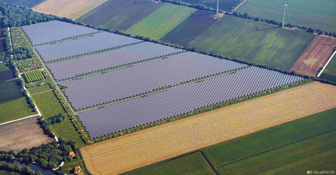Aerial view of a large-scale solar PV farm in Germany with battery storage containers