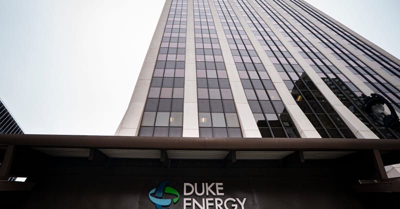 A technician installing solar panels on a European residential rooftop during a sunny day