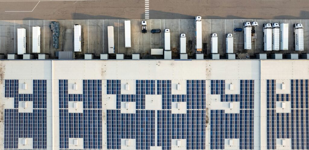 Aerial view of a large-scale solar photovoltaic installation at a municipal waste facility site.