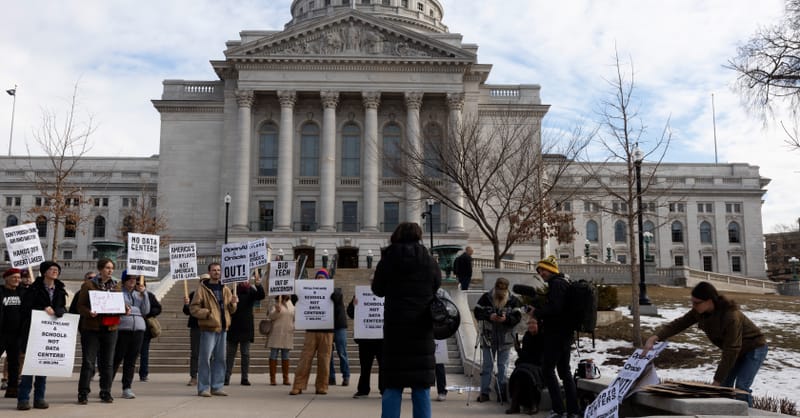 A modern data center building with solar panels installed on its roof and surroundings