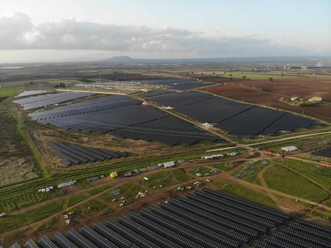 Aerial view of a large-scale hybrid solar and wind farm project in rural France.