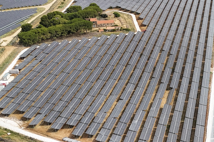 Aerial view of a large-scale solar farm in Italy during construction
