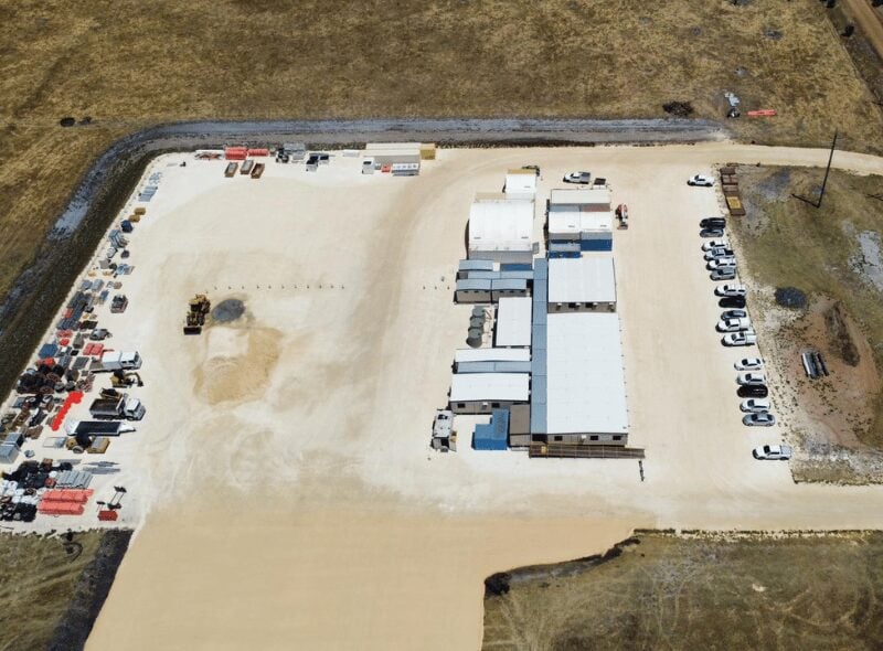 A large-scale industrial battery energy storage system site under construction with grid infrastructure.