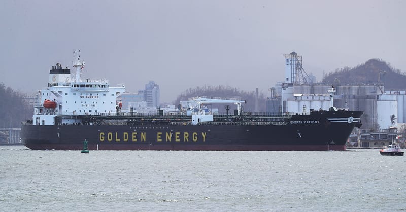 A modern solar panel installation on a residential rooftop with a battery storage unit nearby.