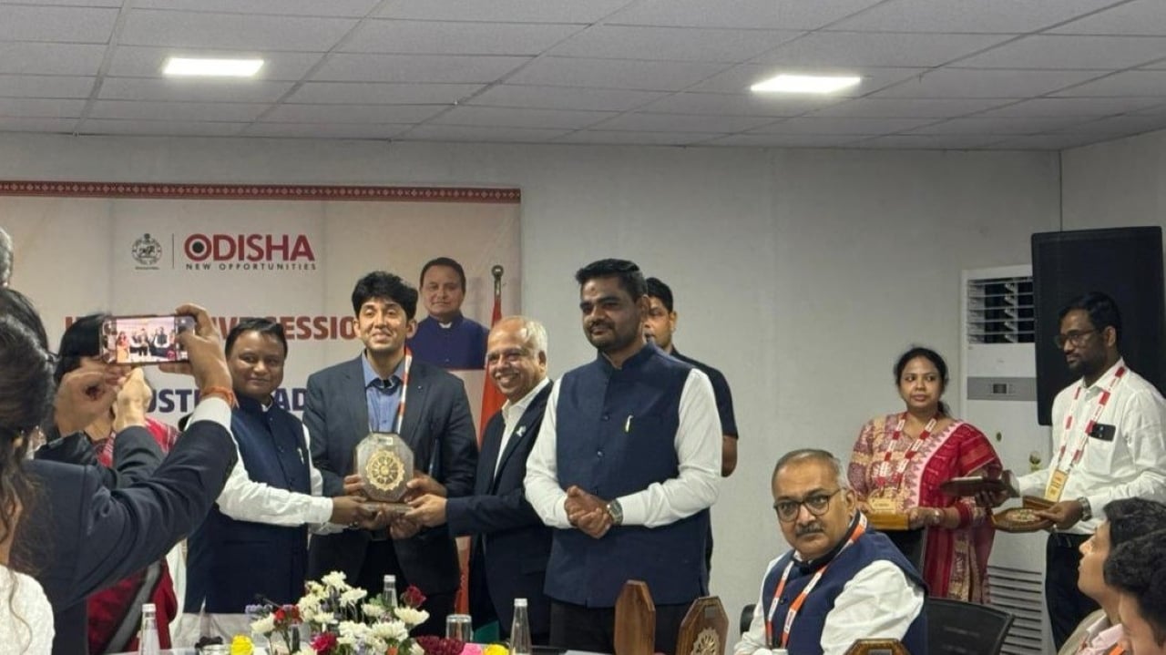 Aerial view of a large-scale solar panel manufacturing facility with assembly lines in operation