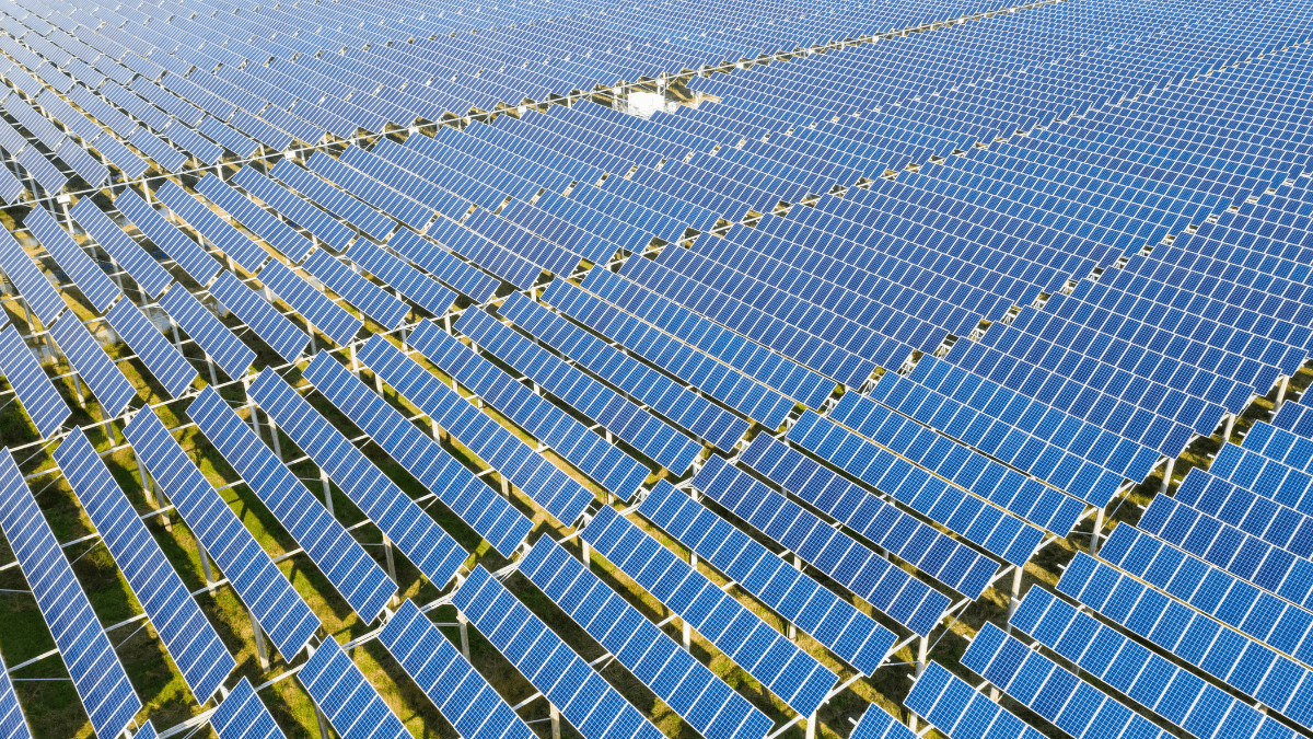 Large scale solar PV installation in a mountainous Balkan landscape with battery storage containers