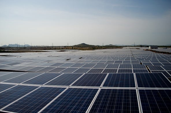 Aerial shot of a massive utility-scale solar farm in the Rajasthan desert