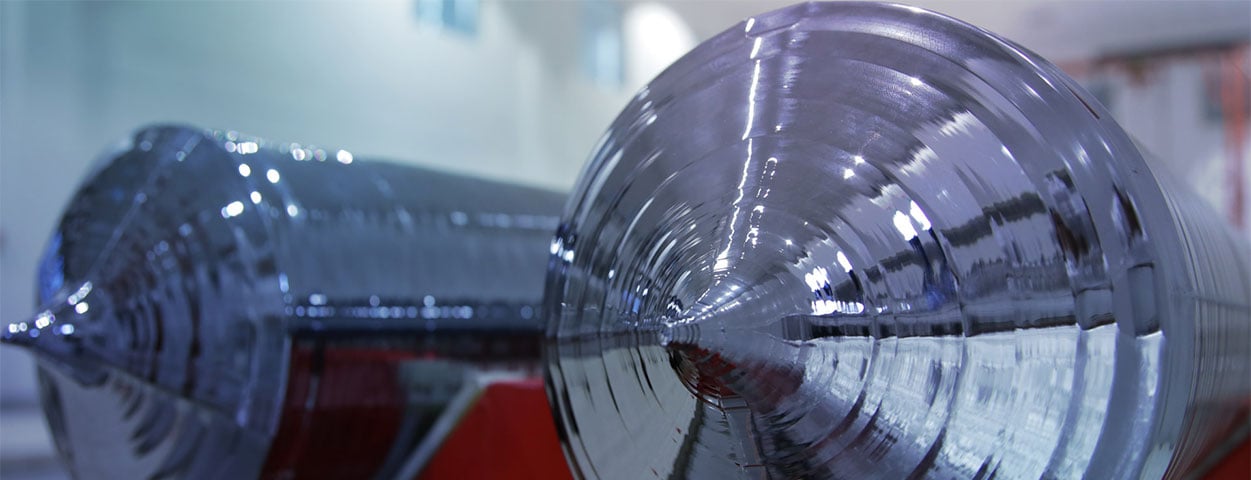 Sunlight hitting a stack of solar panels in a large warehouse