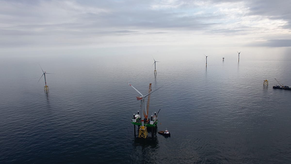 Aerial view of offshore wind turbines in the North Sea with sunlight reflecting on water