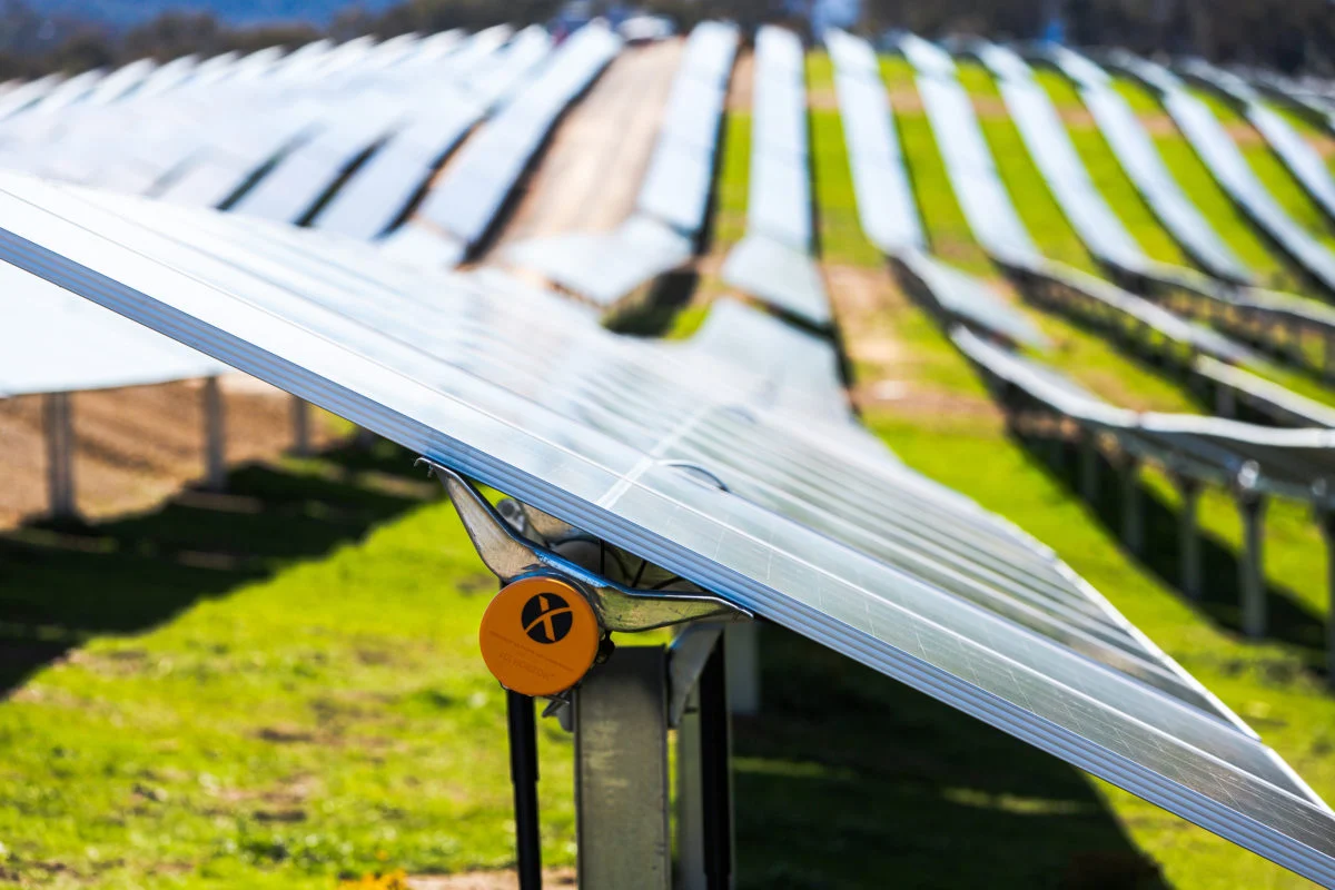 Large scale solar tracker array adjusting angles on a hilly landscape using automated software control.