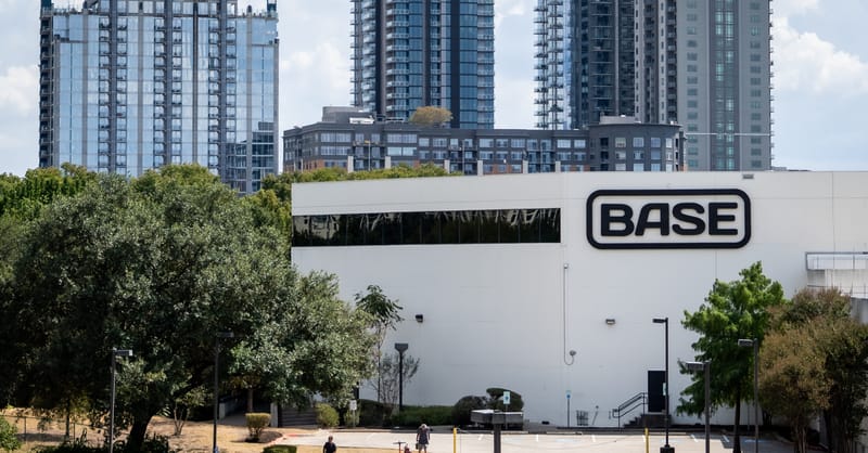 Technician installing a modern home battery system in a residential utility room setup