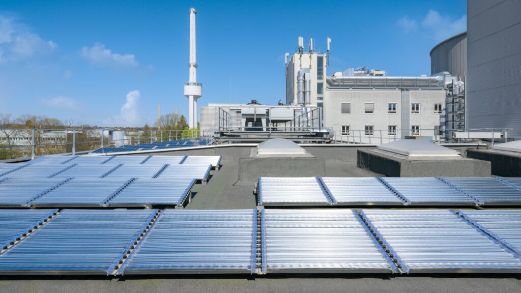 A futuristic solar-hydrogen water-splitting panel unit situated in a sunny desert landscape.