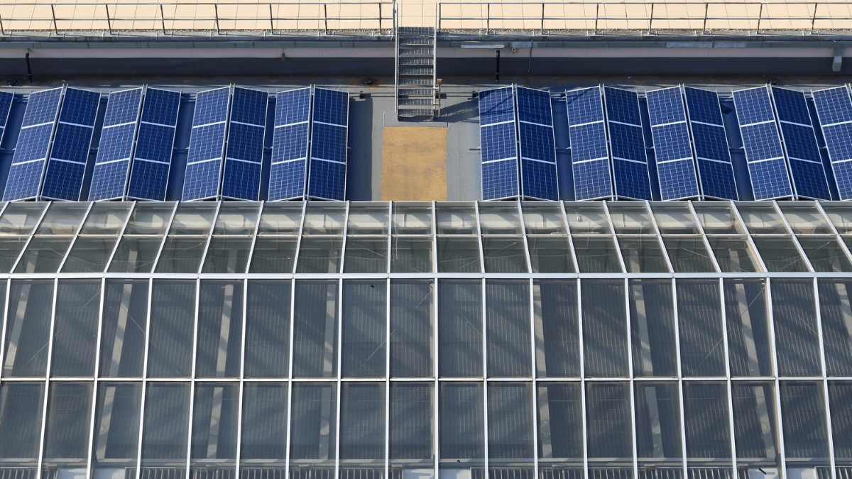 A modern government building with solar panels and a representation of virtual energy sharing across a city grid.