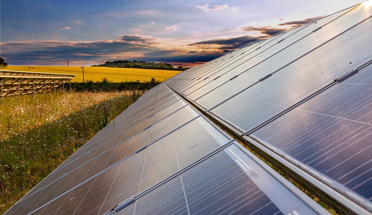 Aerial view of a large-scale solar farm under construction in the English countryside