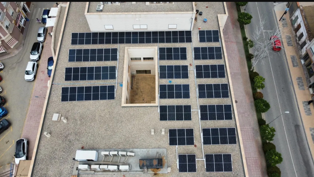 Solar panels installed on the roof of a modern clinical building in Spain