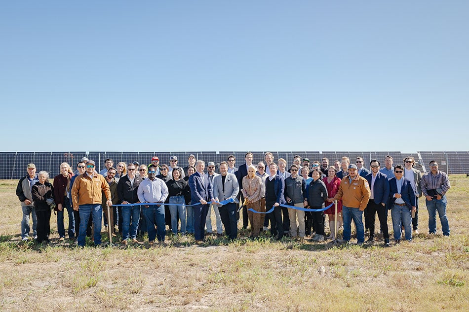 Aerial view of a massive ground-mount solar PV array under a bright Texas sky