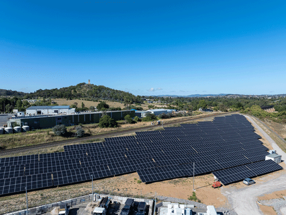 Trinasolar solar panels and battery storage containers installed at a community solar farm site.