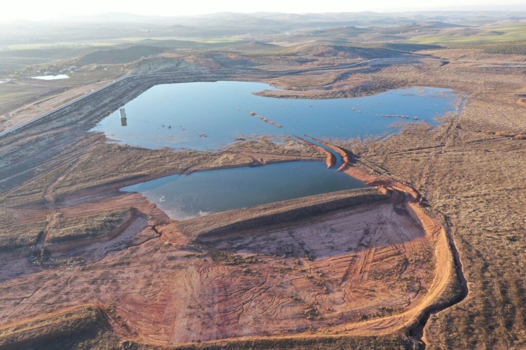Large scale solar PV array installed near a water reservoir in the Spanish countryside for agricultural pumping.