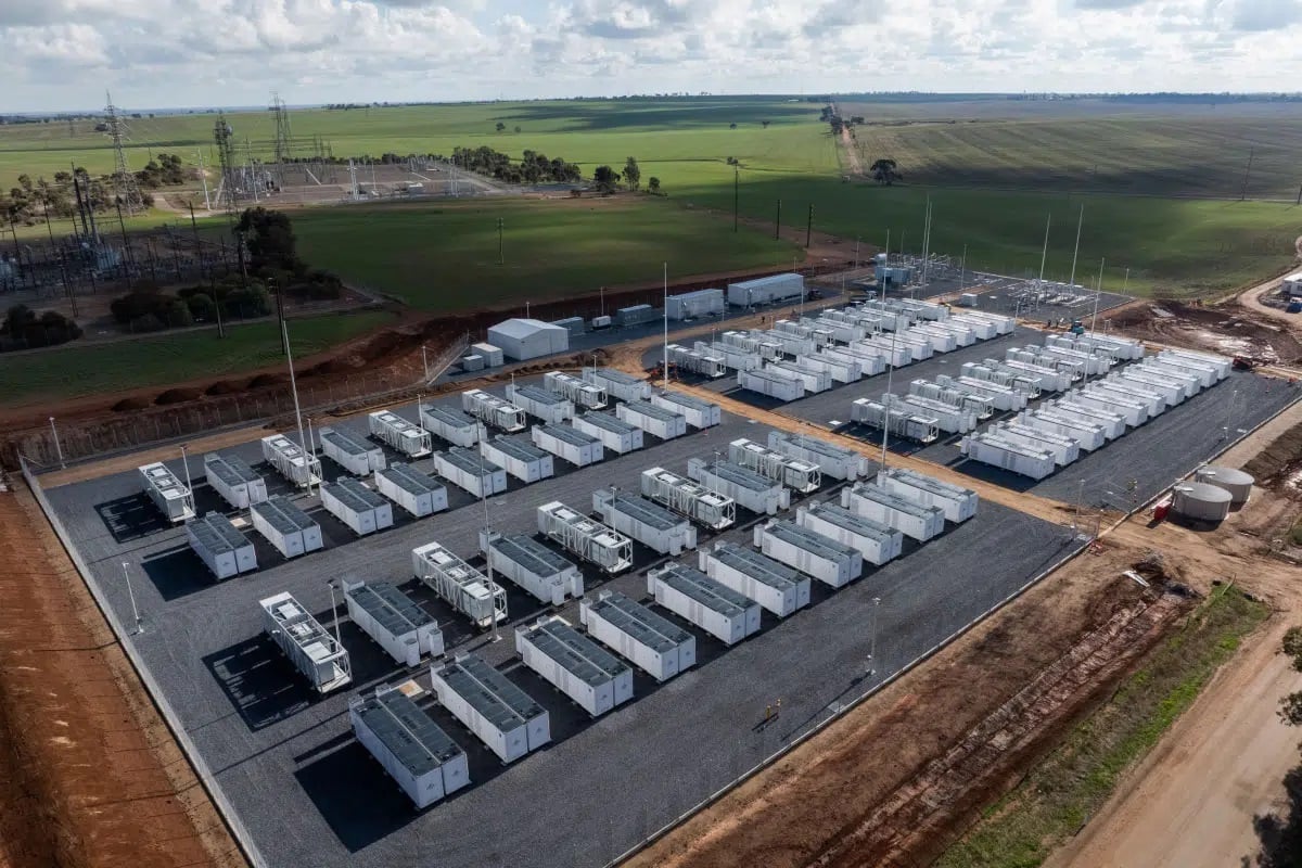 Aerial view of a massive utility-scale battery energy storage system with white containers.