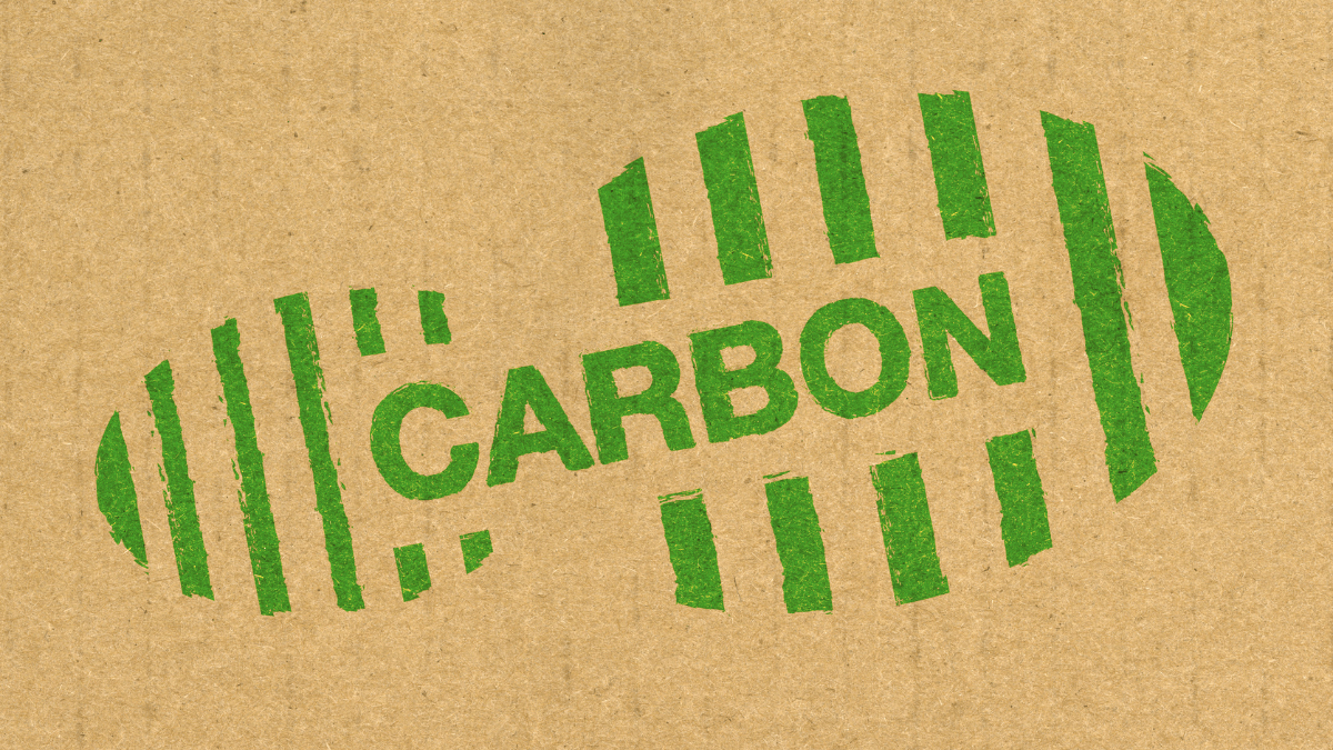 Industrial skyline with heavy emissions representing the carbon intensity of manufacturing and the need for carbon trading schemes.