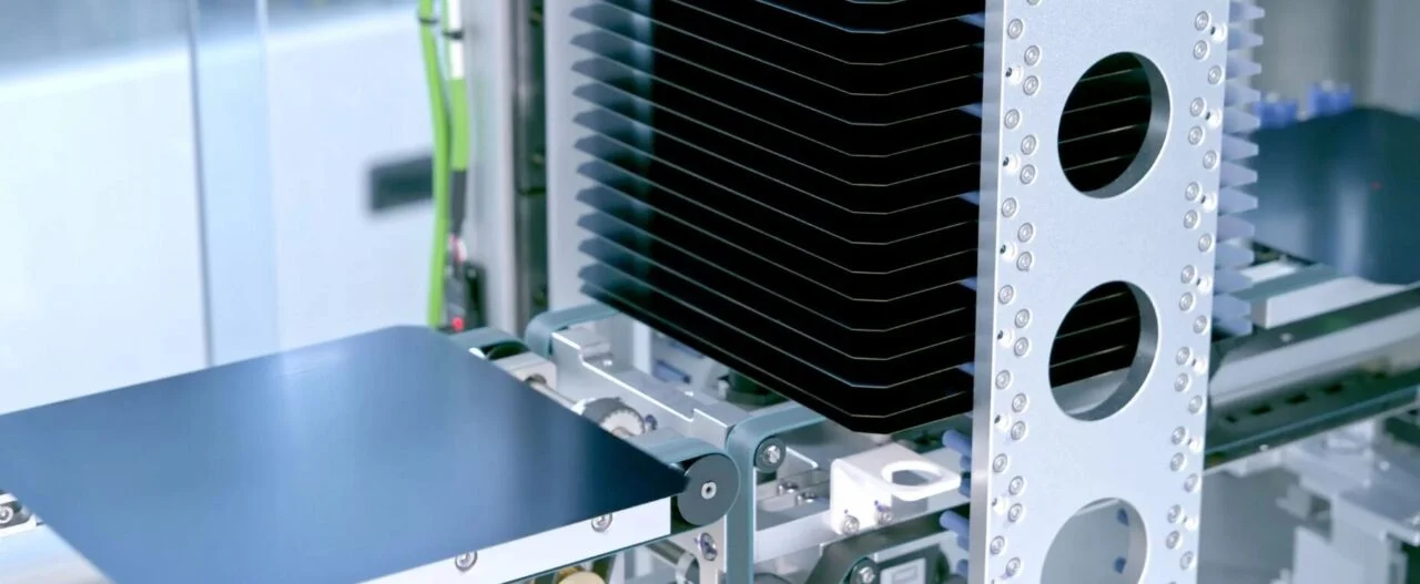 Automated HJT solar cell production line with robotic arms and silicon wafers in a high-tech factory setting.
