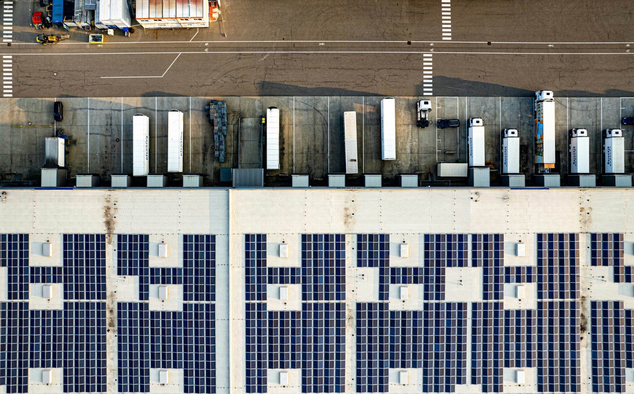 Aerial view of an industrial solar rooftop installation in a coastal region