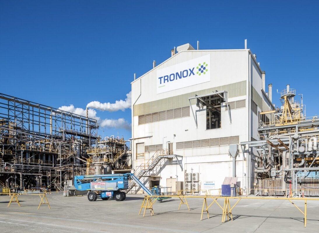 A large industrial facility with thermal energy storage blocks and solar panels integrated into the infrastructure.