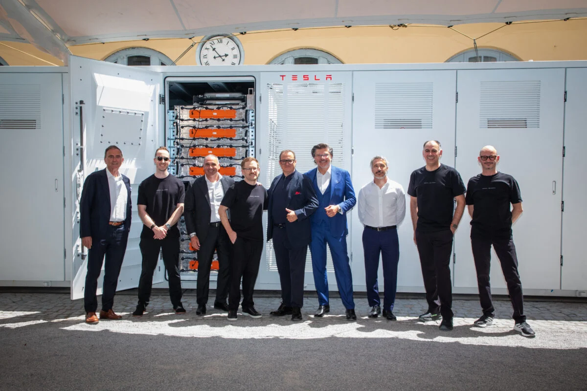 Large scale Tesla Megapack battery storage installation in a field with grey skies