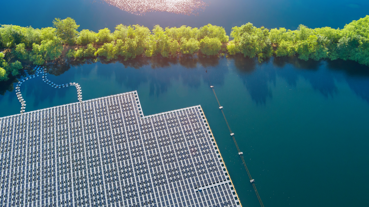 Aerial view of a floating solar array on an industrial water reservoir.