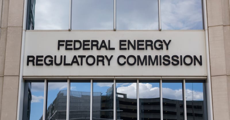 High voltage power lines against a sunset, symbolizing grid infrastructure challenges for solar energy.