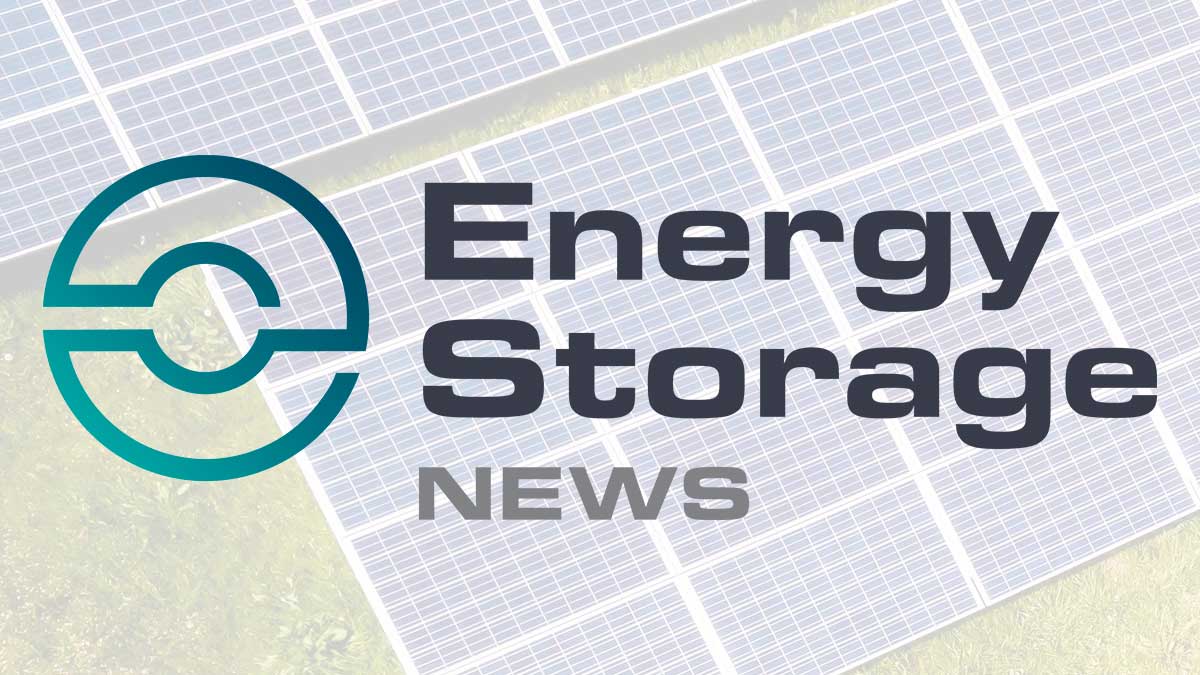 A technician inspecting a large-scale commercial battery energy storage system unit on site