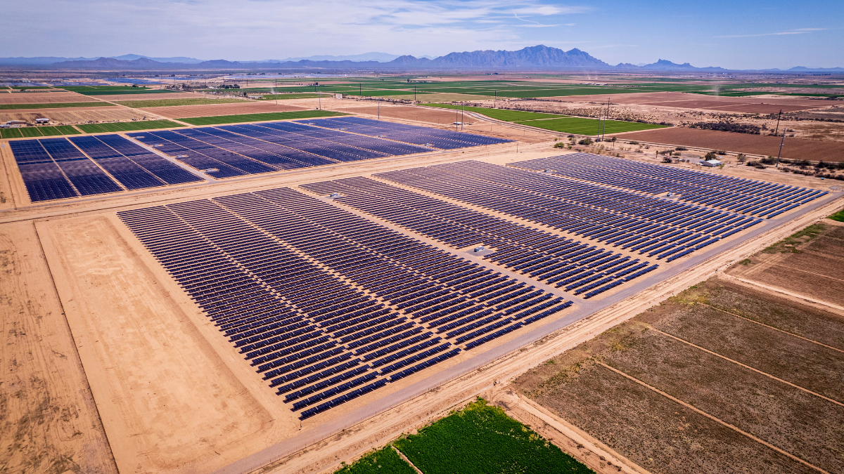 Large scale solar farm under construction in a desert landscape