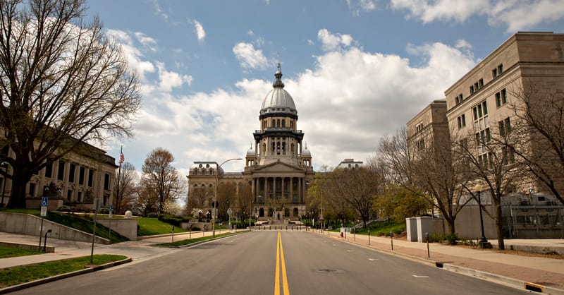 A modern apartment building balcony featuring a compact, plug-in solar panel array.