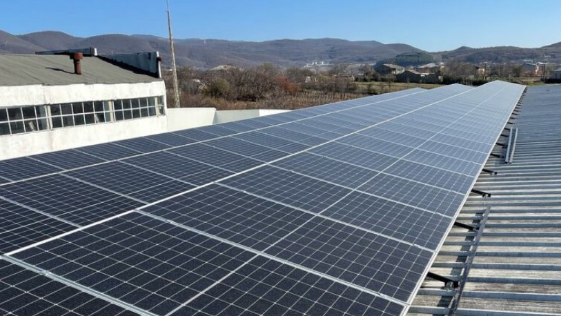 Workers installing solar panels on a school roof in northern Spain