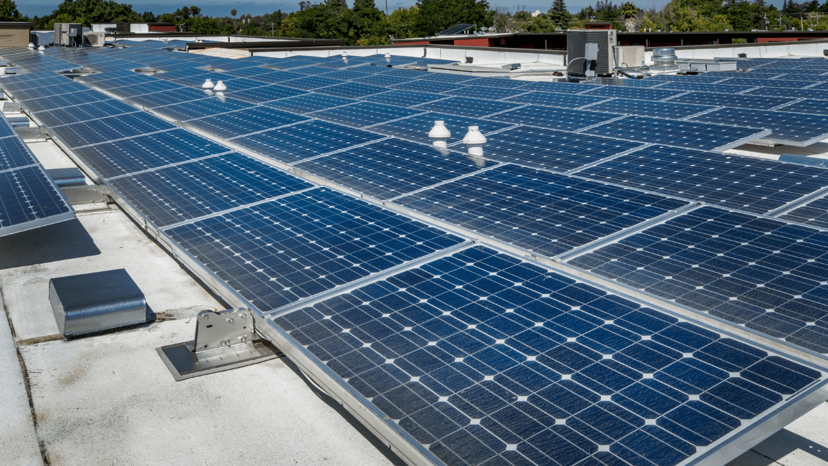 Aerial view of multiple government buildings with solar panel arrays on rooftops
