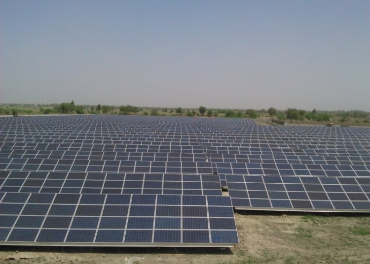 Large scale solar farm integrated with containerized battery energy storage systems in a desert landscape