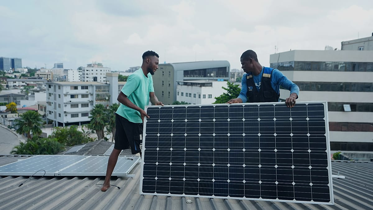A modern residential rooftop solar installation against a clear blue sky during sunset.