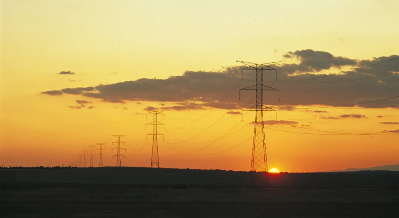 A modern utility-scale battery storage site in rural Spain under a bright sun.