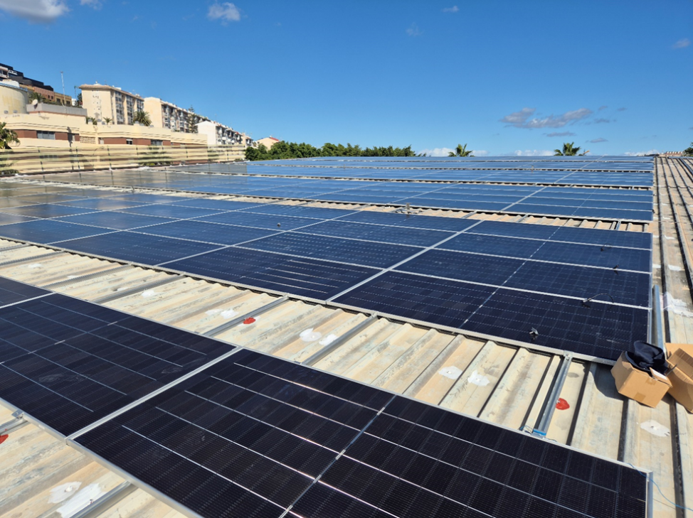 Large scale PV installation on a silver metallic sports center roof with bifacial modules