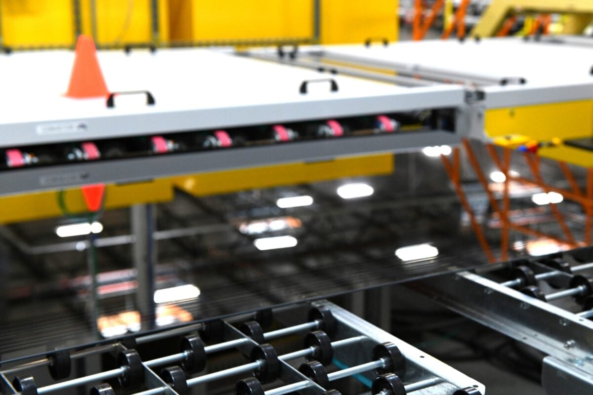 A technician inspecting a high-efficiency solar module in a laboratory environment