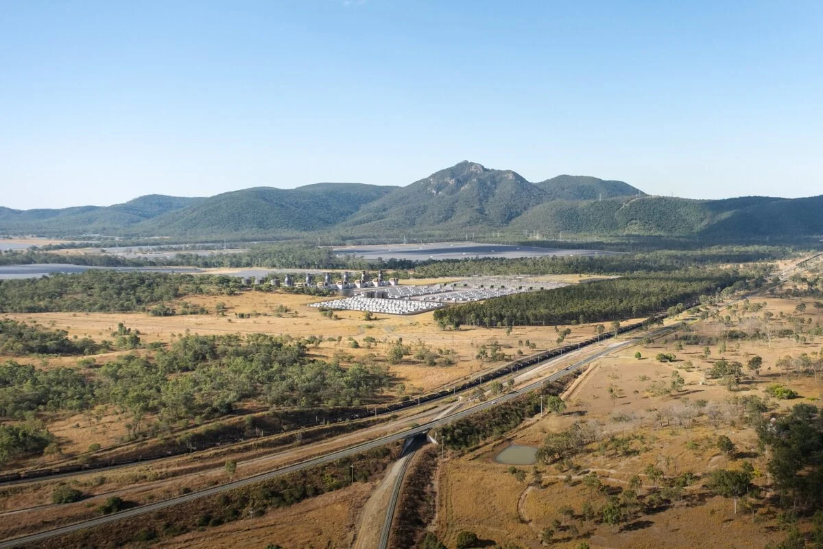 A large-scale battery energy storage system installation with solar panels in the background.