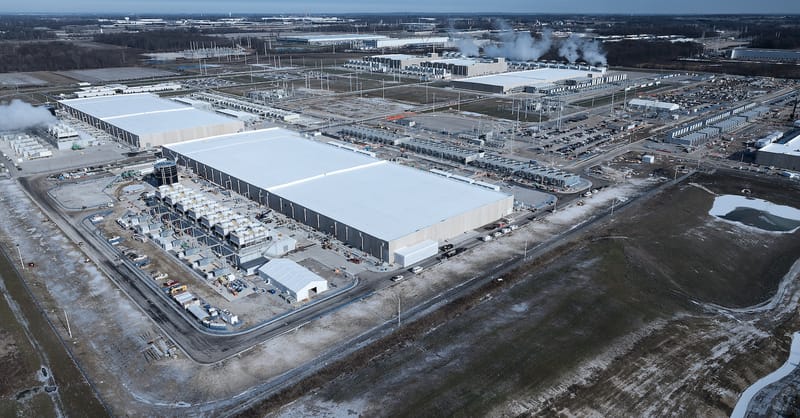 A large-scale iron-air battery facility showing industrial storage modules in a field setting.