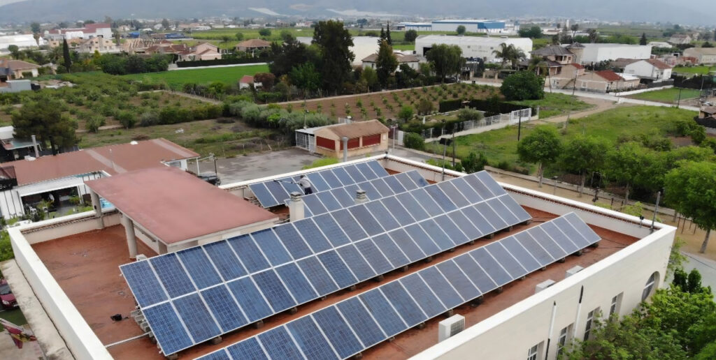 Solar panels installed on the flat roof of a municipal building in Murcia, Spain