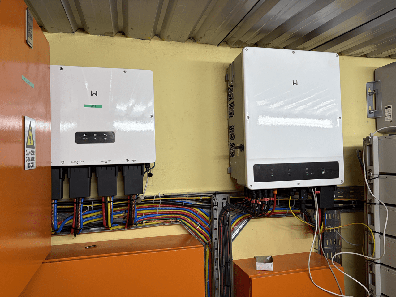 A GoodWe ET 50kW hybrid inverter installed in an industrial setting with battery storage.