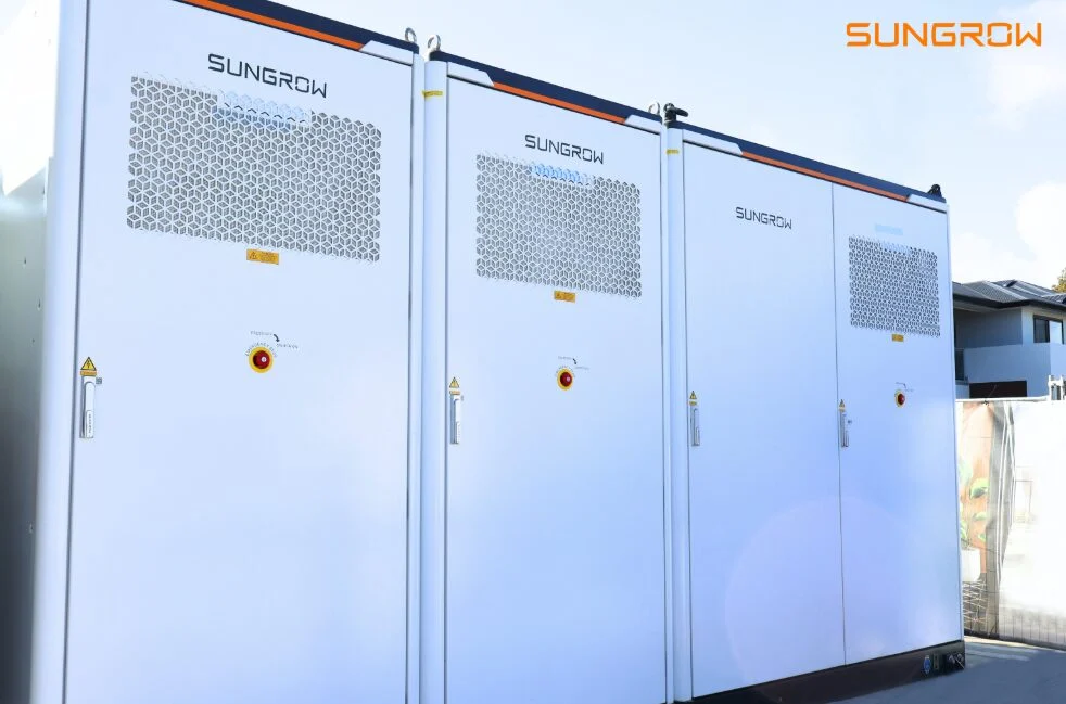 Rows of white Sungrow PowerTitan 2.0 liquid-cooled BESS containers in a desert environment.